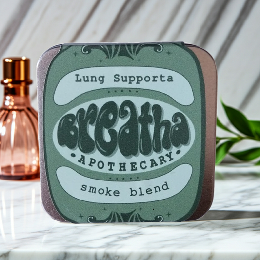 Tin labeled 'Breathe Apothecary' with 'Lung Support' on a marble surface.