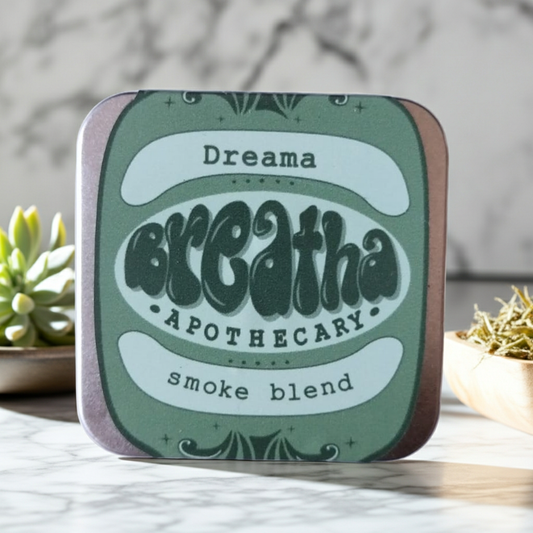Tin labeled 'Dreama Breatha Apothecary smoke blend' on a neutral background